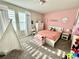 Charming bedroom with playful decor, a cozy bed, and a bright, inviting atmosphere at 1513 Congaree St # 1513, Davenport, FL 33837