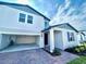 Charming two-story home featuring brick paver driveway, attached two-car garage, and welcoming entrance at 1513 Congaree St # 1513, Davenport, FL 33837