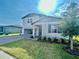 Charming two-story home featuring landscaped yard, brick paver driveway, and attached two-car garage at 1513 Congaree St # 1513, Davenport, FL 33837