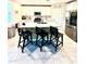 Modern kitchen with white cabinets, a kitchen island with barstool seating, and stainless steel appliances at 1513 Congaree St # 1513, Davenport, FL 33837