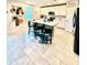 Modern kitchen with white cabinets, a kitchen island with barstool seating, and stainless steel appliances at 1513 Congaree St # 1513, Davenport, FL 33837