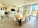 Open-concept living space featuring a dining area, a modern sofa, and a sliding glass door at 1513 Congaree St # 1513, Davenport, FL 33837