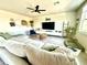Cozy living room with a sectional sofa, modern decor, accent wall, and ample natural light at 1513 Congaree St # 1513, Davenport, FL 33837