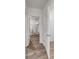 Hallway featuring doors to walk-in closets with shelving units at 1521 Redwood Ln, Lake Hamilton, FL 33851
