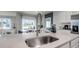 Close-up of a modern kitchen sink with stylish faucet and open view to dining area at 1521 Redwood Ln, Lake Hamilton, FL 33851