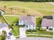 Beautiful two-story home featuring manicured lawn, white picket fence, and lush landscaping on a golf course at 219 Strathmore Cir, Kissimmee, FL 34744
