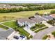 Aerial view of a gray two-story home with lush lawn, mature trees, and manicured landscaping at 219 Strathmore Cir, Kissimmee, FL 34744