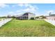 Well-maintained backyard with lush lawn and a white picket fence surrounding the pool area at 219 Strathmore Cir, Kissimmee, FL 34744