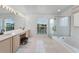 Large bathroom with dual vanities, a soaking tub, and a separate glass-enclosed shower at 219 Strathmore Cir, Kissimmee, FL 34744