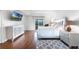 Modern bedroom features hardwood floors, a stylish dresser, and balcony access for natural light at 219 Strathmore Cir, Kissimmee, FL 34744