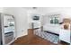 Bright bedroom with hardwood floors, a large bed, and access to a private balcony at 219 Strathmore Cir, Kissimmee, FL 34744
