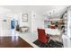 Bright dining area features white tile floors, a modern table with red accents, and an open layout to the kitchen at 219 Strathmore Cir, Kissimmee, FL 34744