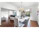 Elegant dining room featuring a white table, chandelier, and open layout to the living room at 219 Strathmore Cir, Kissimmee, FL 34744