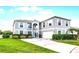 Beautiful two-story home with a well-manicured lawn and driveway leading up to the attached two-car garage at 219 Strathmore Cir, Kissimmee, FL 34744