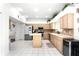 Bright kitchen with light wood cabinets, stainless steel appliances, and a center island at 219 Strathmore Cir, Kissimmee, FL 34744
