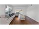 Bright living room with hardwood floors, a neutral-toned sofa, and a view to the dining room at 219 Strathmore Cir, Kissimmee, FL 34744