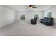 Expansive living room with plush carpeting, bright windows, and comfortable seating for relaxation at 219 Strathmore Cir, Kissimmee, FL 34744