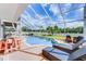 Enclosed backyard pool with sun loungers, seating, and a view of the fenced yard at 219 Strathmore Cir, Kissimmee, FL 34744