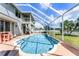 Inviting backyard screened pool with lounge seating, and a spacious outdoor area at 219 Strathmore Cir, Kissimmee, FL 34744