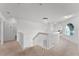 Bright upstairs hallway with a chandelier, carpet flooring, and an arched window at 219 Strathmore Cir, Kissimmee, FL 34744