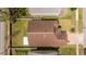 Aerial view of home with a brown roof, well-maintained yard and white fences at 2218 Newt St, Orlando, FL 32837