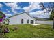 View of the backyard with a gray house, arched windows and a new white patio at 2218 Newt St, Orlando, FL 32837
