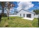 Backyard view showcasing the house's rear facade with a sliding door and arched windows at 2218 Newt St, Orlando, FL 32837