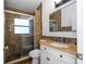 Bathroom features a mosaic tiled wall, a vanity with granite countertop, and a glass enclosed shower at 2218 Newt St, Orlando, FL 32837