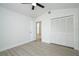 Bedroom with a ceiling fan, an open closet and light hardwood floors at 2218 Newt St, Orlando, FL 32837