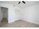 Bedroom with a ceiling fan, an open closet and light hardwood floors at 2218 Newt St, Orlando, FL 32837