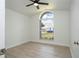 Bright bedroom featuring a modern ceiling fan and a half-moon window at 2218 Newt St, Orlando, FL 32837