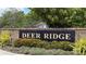 Deer Ridge entrance sign, a brick structure enhanced by landscaping, conveys a welcoming and established community at 2218 Newt St, Orlando, FL 32837
