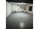 Spacious garage with epoxy flooring, utility sink, and water heater at 2218 Newt St, Orlando, FL 32837