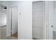 Hallway view with an open pantry featuring white wire shelving at 2218 Newt St, Orlando, FL 32837