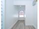Bright hallway features light hardwood floors and a distinctive half-moon window at 2218 Newt St, Orlando, FL 32837
