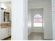 Bright hallway features light hardwood floors and a distinctive half-moon window at 2218 Newt St, Orlando, FL 32837