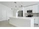 Modern kitchen featuring white cabinetry, stainless steel appliances, and a large island with pendant lighting at 2218 Newt St, Orlando, FL 32837