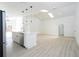 Bright, open-concept living area with skylights, modern pendant lights, and a kitchen island at 2218 Newt St, Orlando, FL 32837