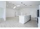 Bright, open-concept living area featuring vaulted ceilings, skylights, and a modern kitchen island at 2218 Newt St, Orlando, FL 32837