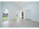 Bright main bedroom with light wood floors, arched windows, and a closet with bi-fold doors at 2218 Newt St, Orlando, FL 32837
