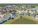 Neighborhood aerial view showcases homes with screened pools, lush landscaping, and community amenities at 2315 Anhinga Dr, Kissimmee, FL 34743