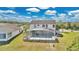 Large backyard with a screened-in pool and ample space for outdoor enjoyment and entertaining at 2315 Anhinga Dr, Kissimmee, FL 34743