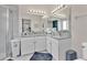 Bathroom features a double vanity with granite counters and a large mirror at 2315 Anhinga Dr, Kissimmee, FL 34743