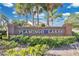 Entrance sign of Flamingo Lakes community amid lush landscaping at 2315 Anhinga Dr, Kissimmee, FL 34743