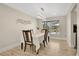 Dining room with modern chandelier and serene view of screened lanai overlooking the water at 2315 Anhinga Dr, Kissimmee, FL 34743
