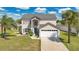 Inviting home featuring a lush lawn and a spacious two-car garage at 2315 Anhinga Dr, Kissimmee, FL 34743