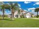 Gorgeous home with lush green lawn and mature palms at 2315 Anhinga Dr, Kissimmee, FL 34743