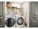 Functional laundry room with modern washer, dryer and shelving at 2315 Anhinga Dr, Kissimmee, FL 34743
