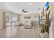 Bright living room features tile floors, ceiling fan, and sliding glass doors to the lanai at 2315 Anhinga Dr, Kissimmee, FL 34743