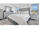 Luxurious main bedroom offers a gray upholstered headboard and abundant natural light at 2315 Anhinga Dr, Kissimmee, FL 34743